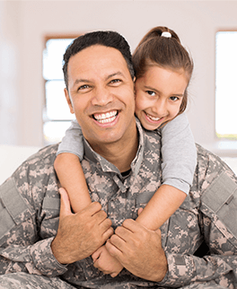 solider and his daughter in their home