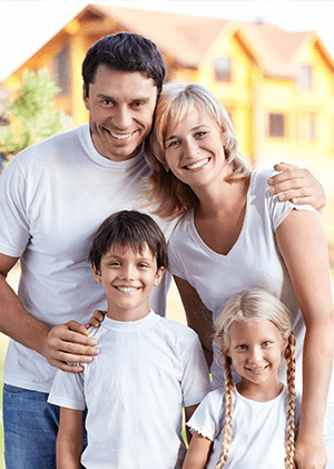 happy family in front of their new home